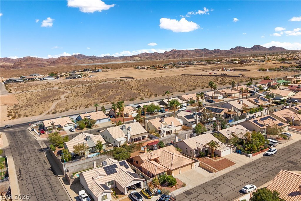 120 Ringlore Road Henderson, NV 89015 - Photo 53 of 58 Aerial perspective reveals a quiet neighborhood nestled against a vast desert mountain landscape.