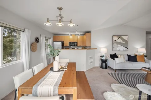 a bedroom with a large bed and wooden floor