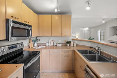 a kitchen with a sink stove and microwave