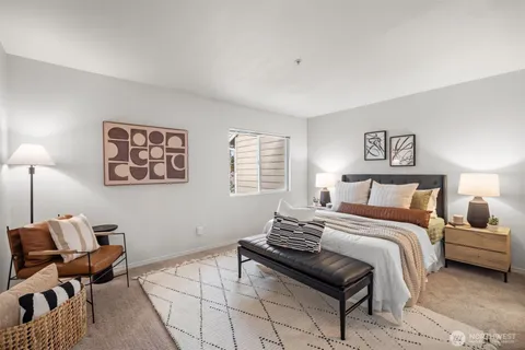 a bedroom with a bed and a lamp on table