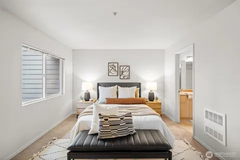 a bedroom with a large bed and a window