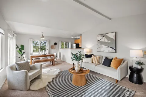 a living room with furniture a rug and a lamp