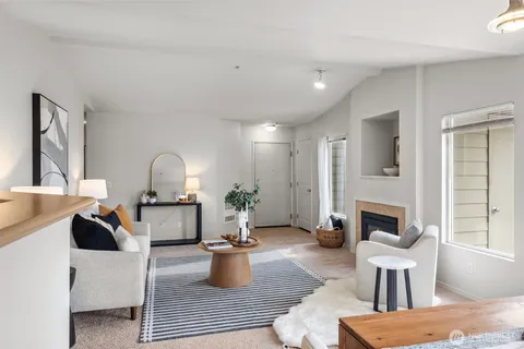 a living room with furniture a fireplace and a table