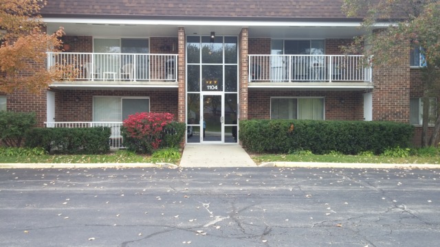 1104 Springinsguth Road, Unit 1B Schaumburg, IL 60193 - Photo 1 of 11 a front view of house with yard