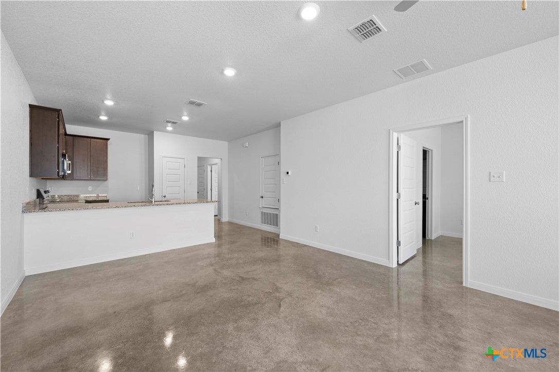 2819 Quail Rdg Lane Temple, TX 76501 - Photo 7 of 17 a view of an empty room with kitchen and a window