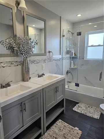 a bathroom with a double vanity sink and a mirror