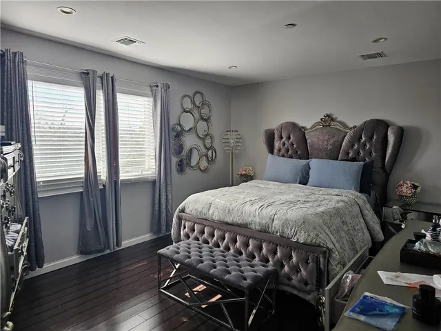 a bedroom with a bed with wooden floor