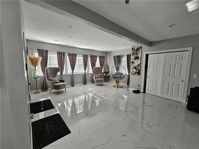 a view of a livingroom with furniture and floor to ceiling window