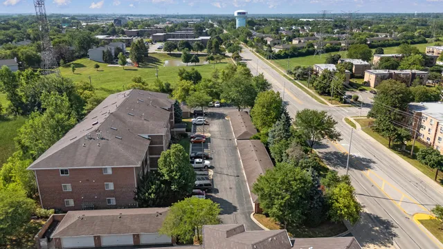 an aerial view of city lake and trees