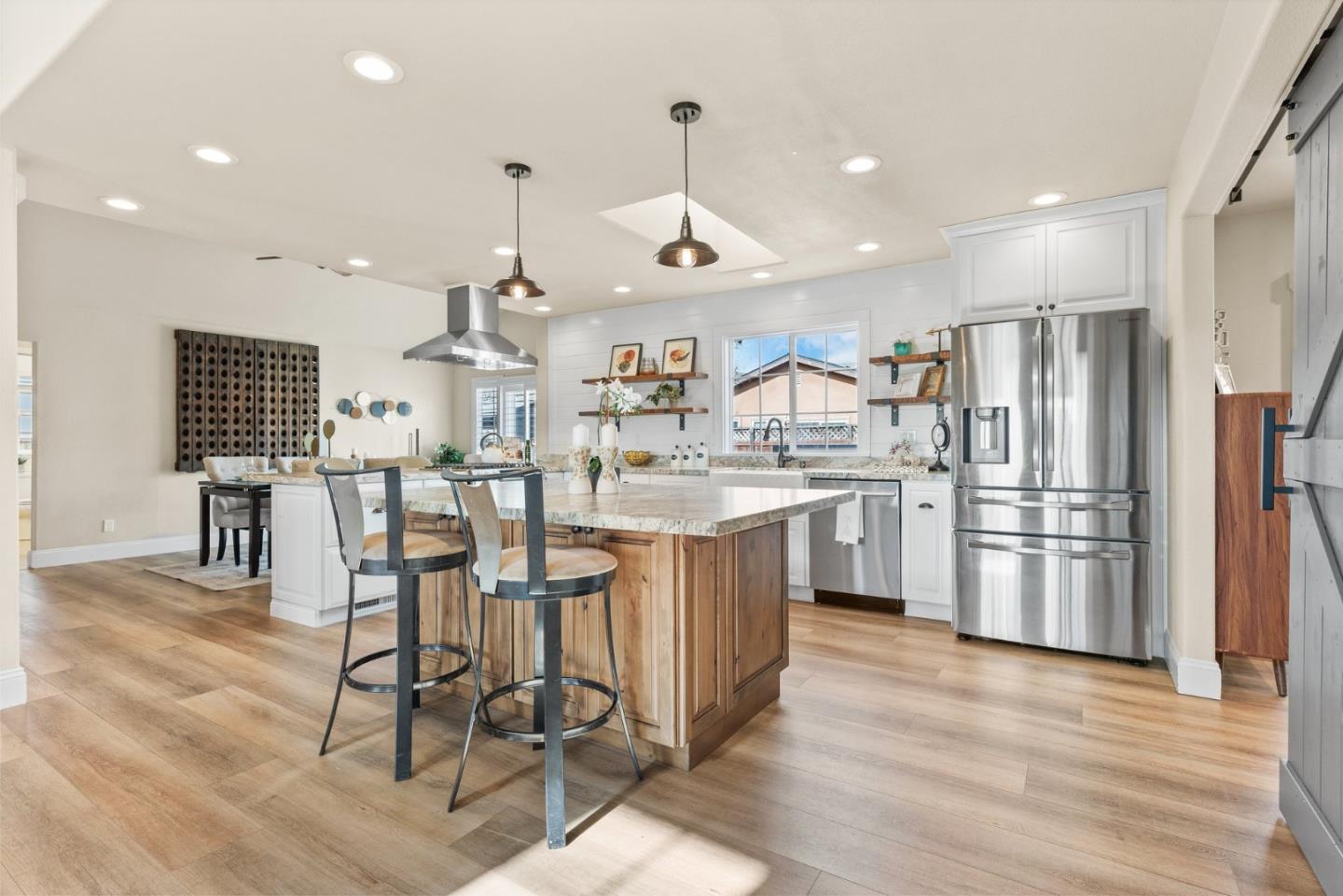 75 Paloma Drive Morgan Hill, CA 95037 - Photo 12 of 53 a kitchen with stainless steel appliances kitchen island granite countertop a stove a sink dishwasher and a refrigerator with wooden floor