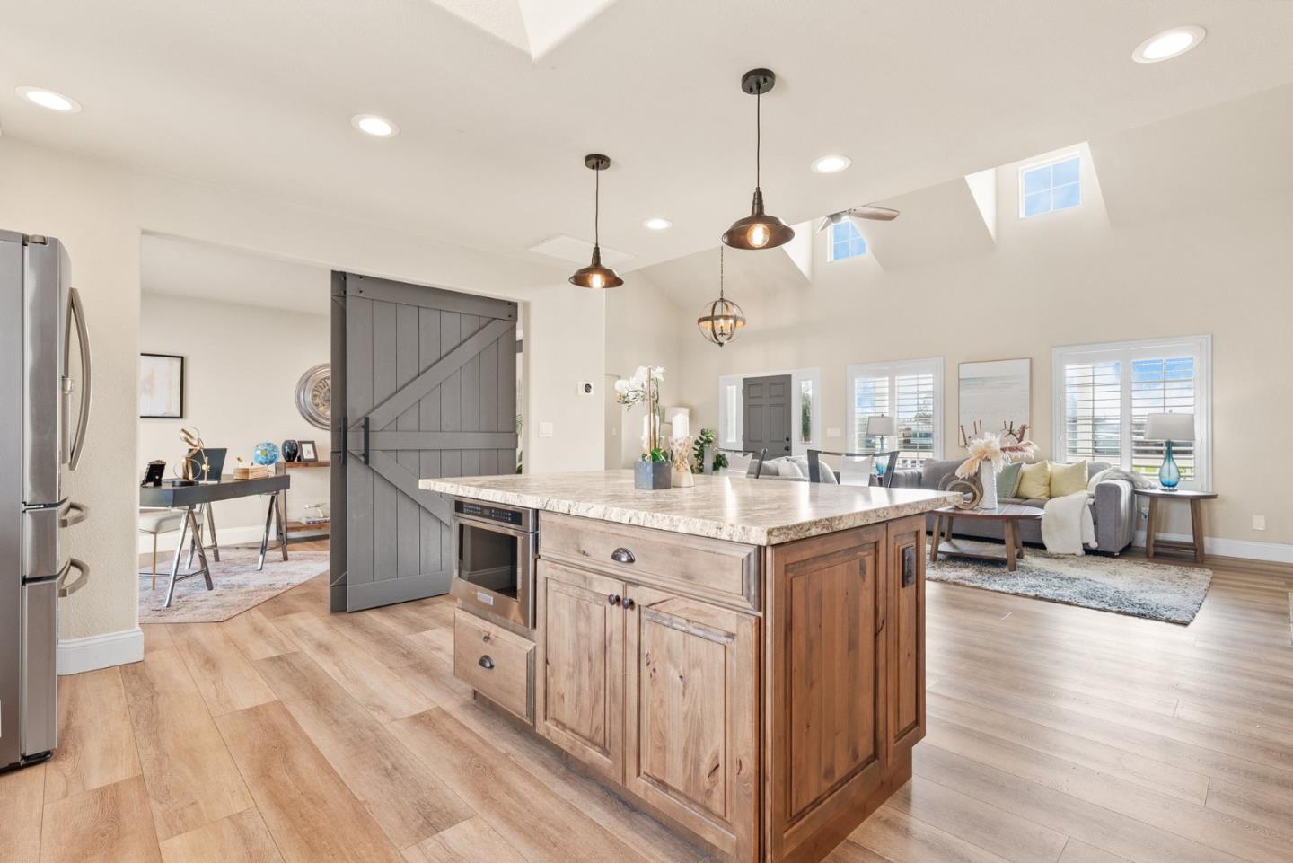 75 Paloma Drive Morgan Hill, CA 95037 - Photo 14 of 53 a kitchen with stainless steel appliances kitchen island granite countertop a lot of cabinets and wooden floor