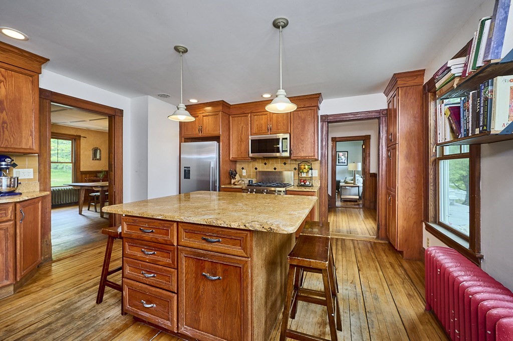 39 Laurel Mountain Road Haydenville, MA 01039 - Photo 3 of 42 a dining hall with stainless steel appliances granite countertop a stove and wooden floors