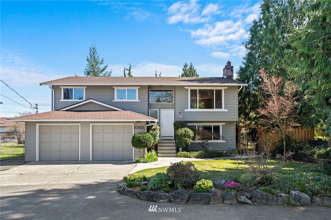 10831 38th Drive Southeast Everett, WA 98208 - Photo 1 of 40 a front view of a house with garden