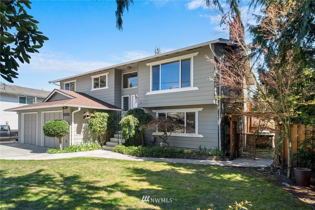 10831 38th Drive Southeast Everett, WA 98208 - Photo 2 of 40 a front view of a house with a yard and potted plants