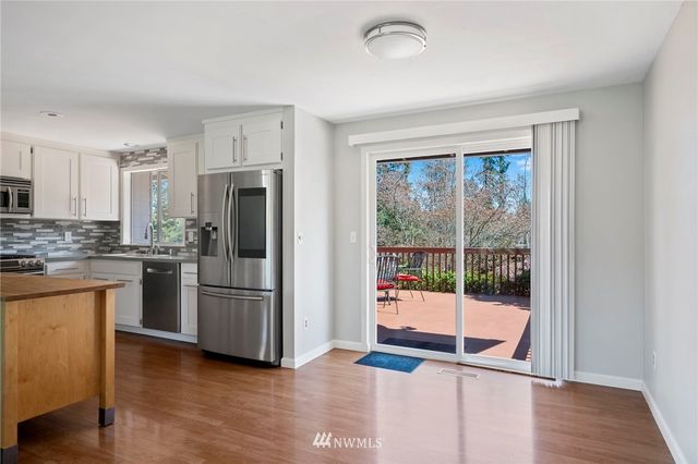 a kitchen with stainless steel appliances granite countertop a refrigerator and a sink