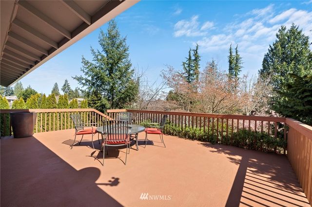 a view of a chairs and table in the balcony