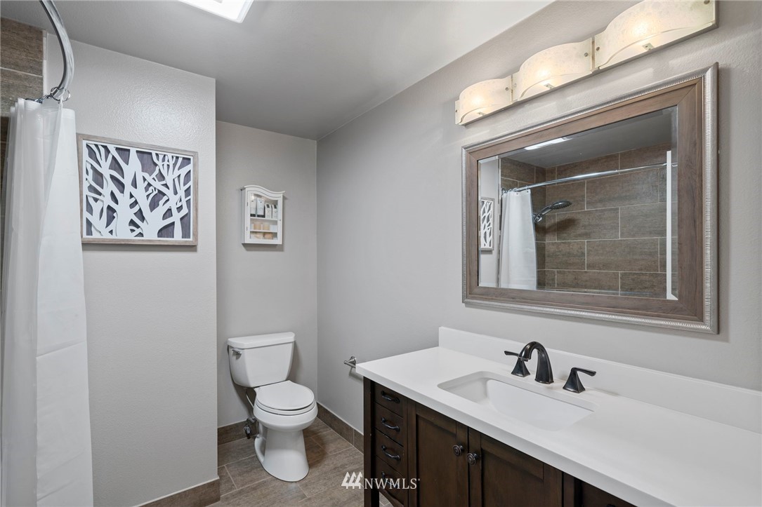 10831 38th Drive Southeast Everett, WA 98208 - Photo 14 of 40 a bathroom with a toilet sink and mirror