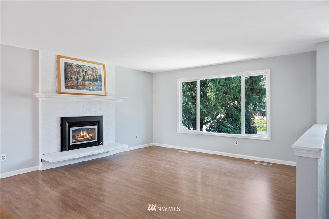 10831 38th Drive Southeast Everett, WA 98208 - Photo 3 of 40 an empty room with a fireplace and a window