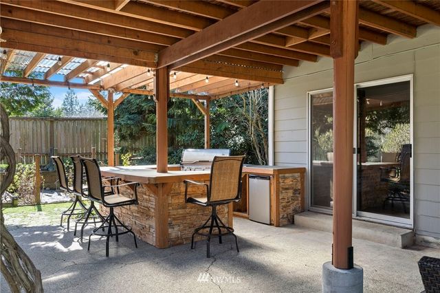 a view of an outdoor dining space with a backyard