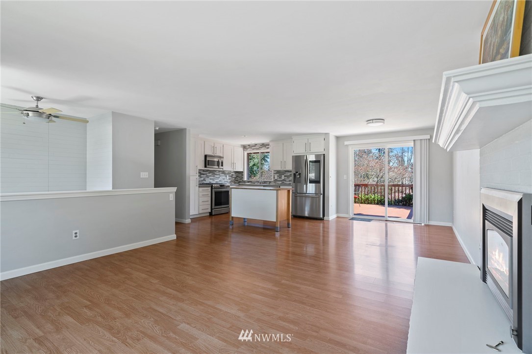 10831 38th Drive Southeast Everett, WA 98208 - Photo 4 of 40 a view of an empty room with wooden floor and a window
