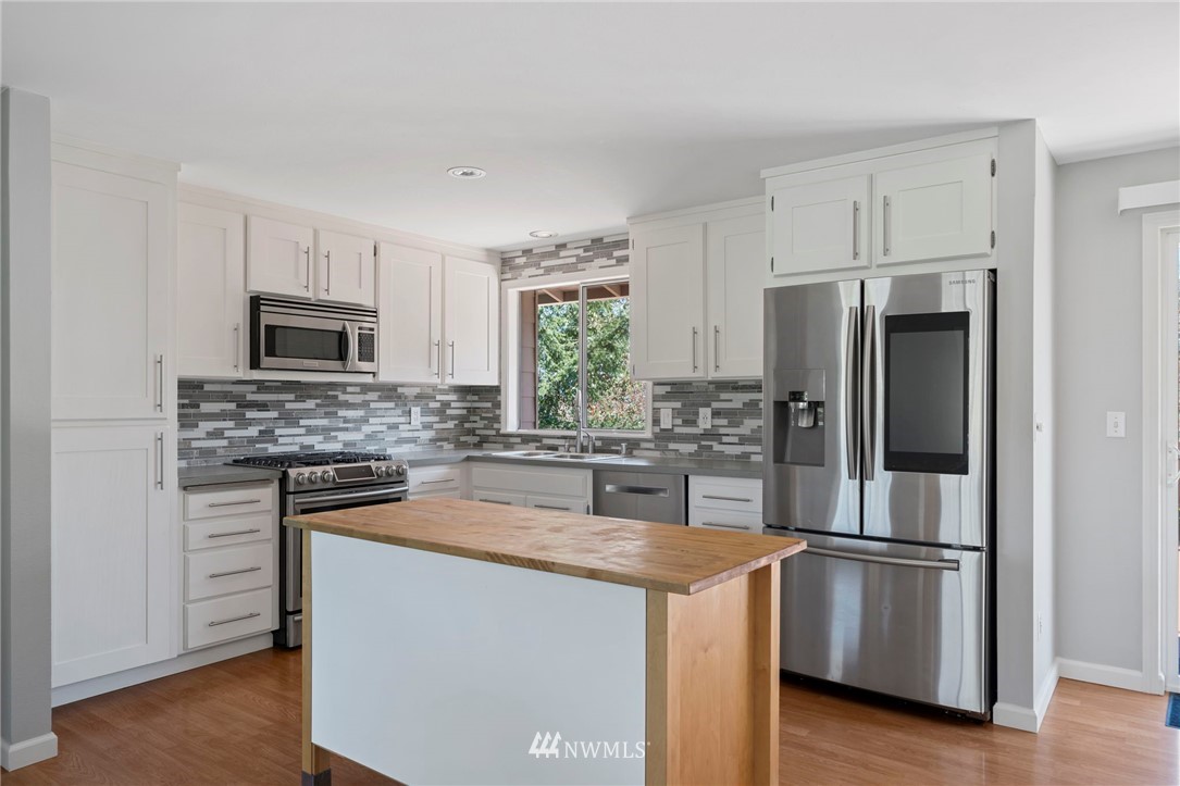 10831 38th Drive Southeast Everett, WA 98208 - Photo 6 of 40 a kitchen with a refrigerator stove and microwave