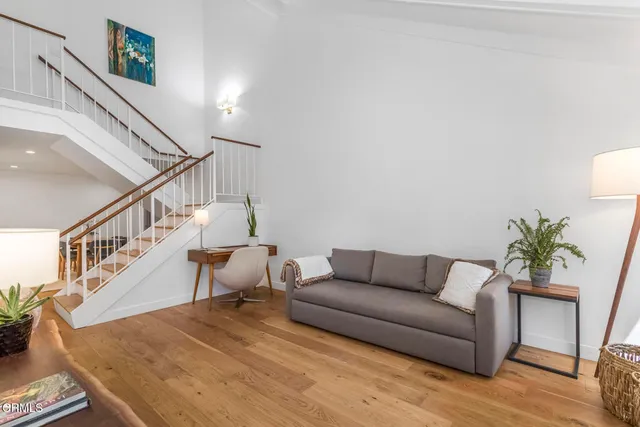 a living room with furniture and a potted plant