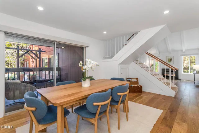 a view of a dining room with furniture and wooden floor