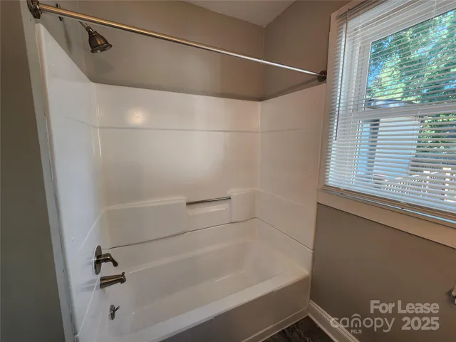 a bathroom with a shower and a bathtub