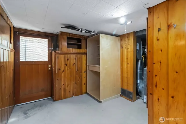 a view of hallway with stainless steel appliances wooden floor and cabinet