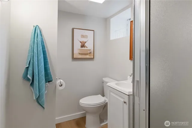 a white toilet sitting next to a shower