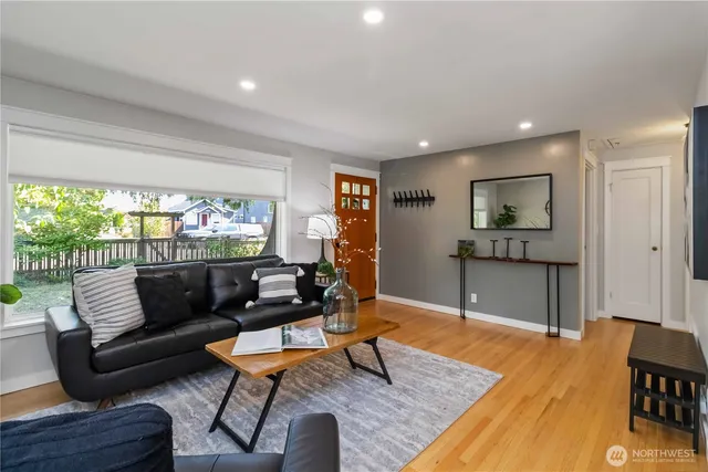 a living room with furniture and a wooden floor