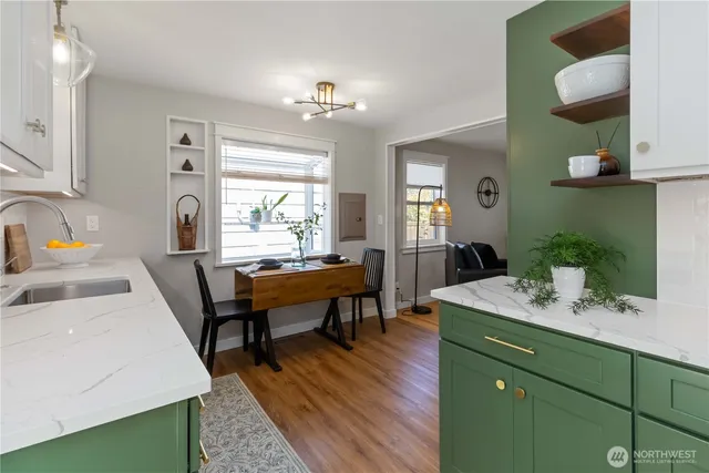 a en suite bathroom with sink a mirror a vanity and window