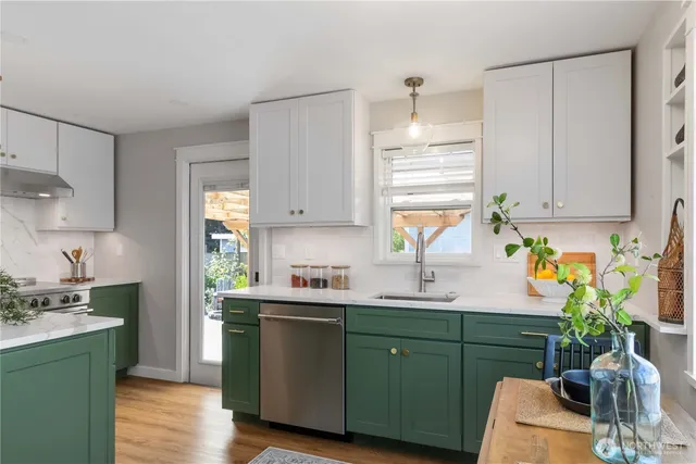 a kitchen with cabinets a window and sink
