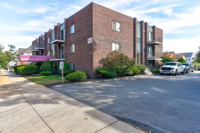 a car parked in front of brick building