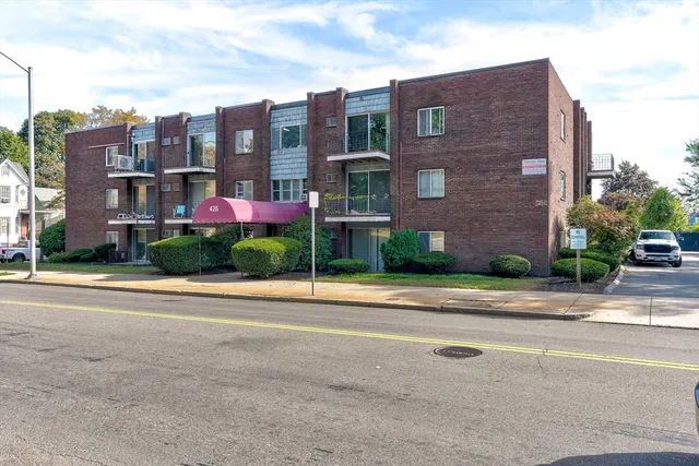 a view of a brick building next to a yard