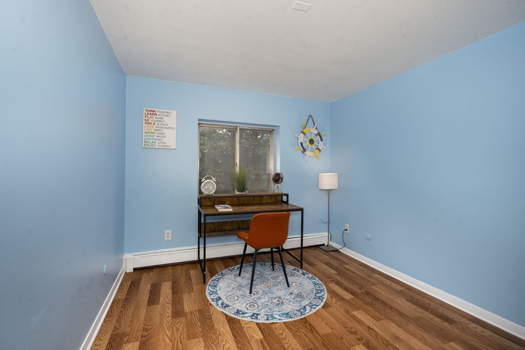 426 Pleasant Street, Unit 17 Malden, MA 02148 - Photo 24 of 36 a workspace with furniture and wooden floor