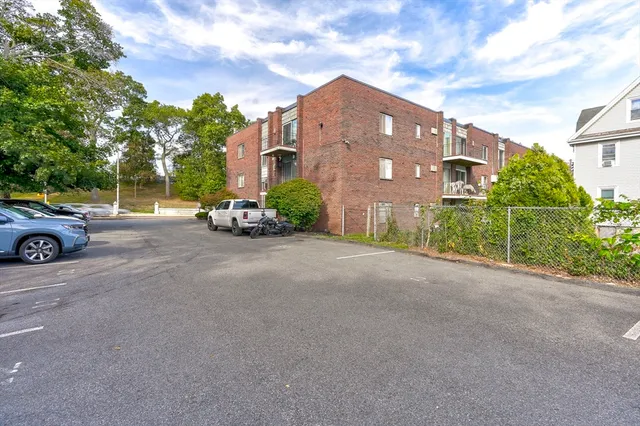 a view of a street with a cars parked in front of it