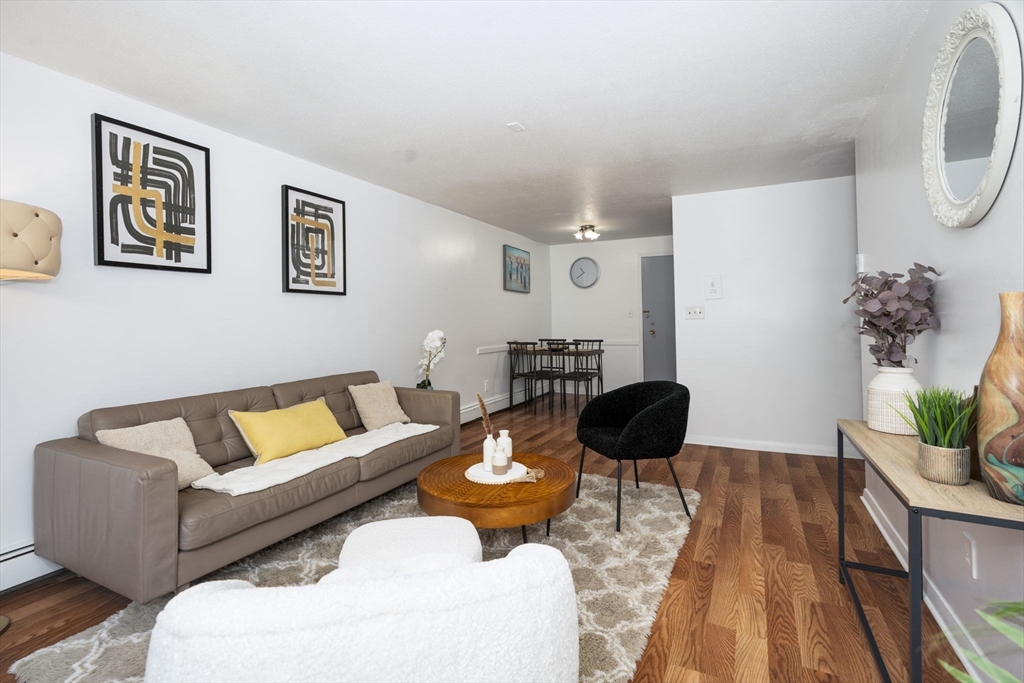 426 Pleasant Street, Unit 17 Malden, MA 02148 - Photo 4 of 36 a living room with furniture and a lamp