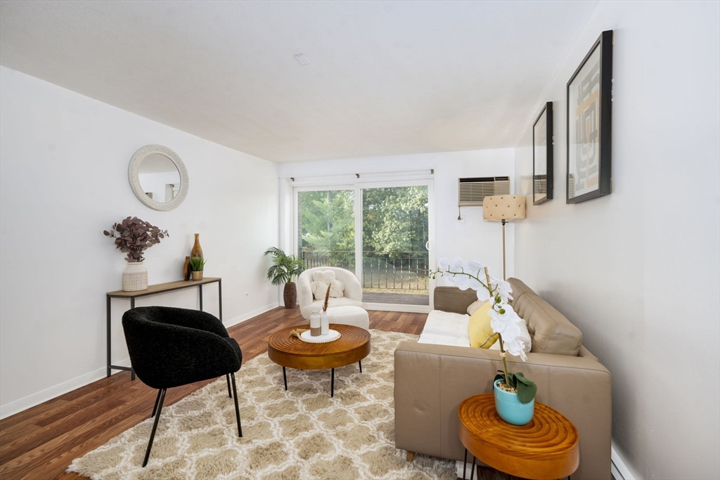 426 Pleasant Street, Unit 17 Malden, MA 02148 - Photo 7 of 36 a living room with furniture and a large window