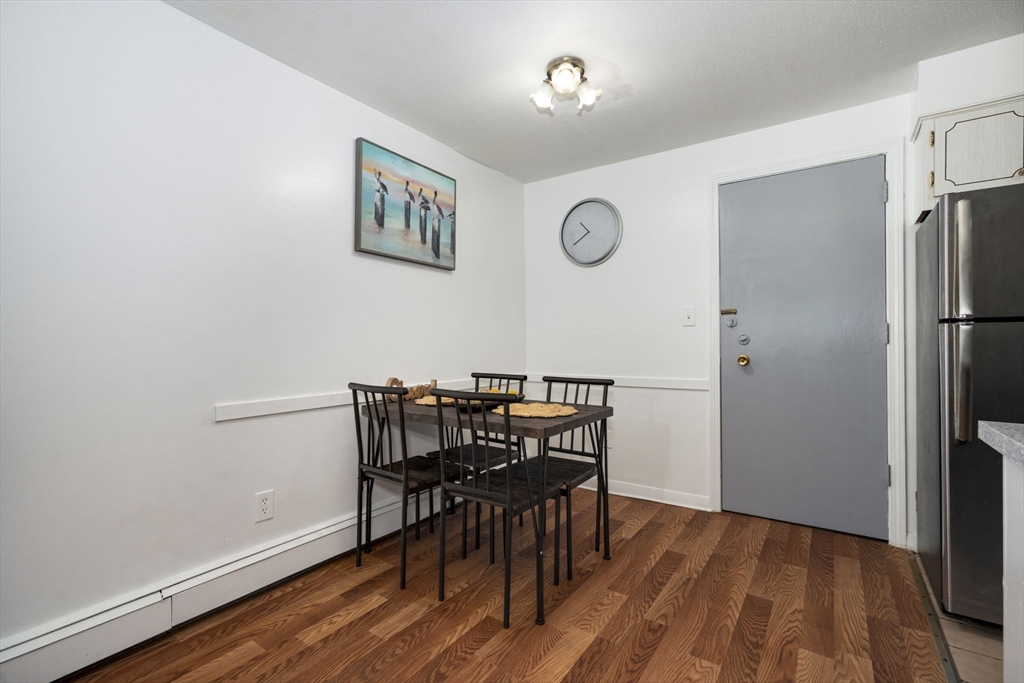 426 Pleasant Street, Unit 17 Malden, MA 02148 - Photo 10 of 36 a view of a dining room with furniture and wooden floor