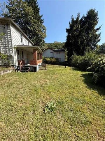 a view of a house with backyard porch and sitting area