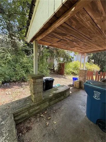 a view of a backyard with table and chairs under an umbrella