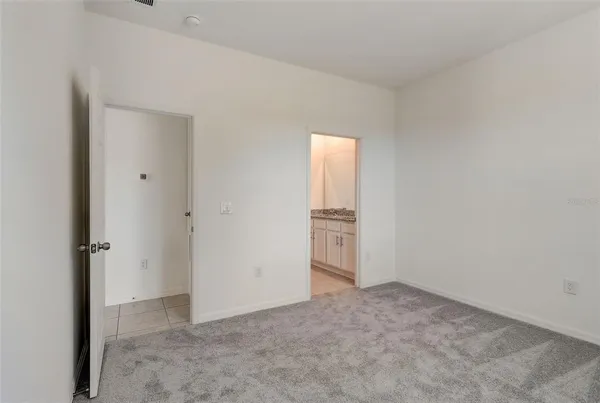 a bathroom with a granite countertop sink and a white white cabinets