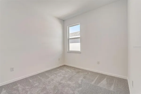 an empty room with closet area