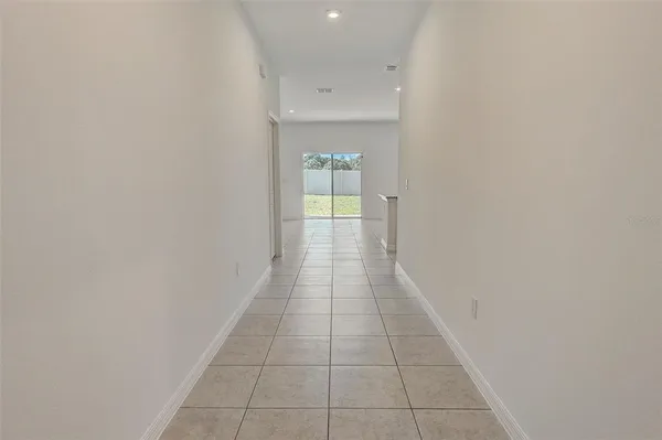a hallway with a window and a rug