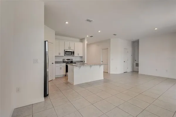 a kitchen with cabinets and stainless steel appliances