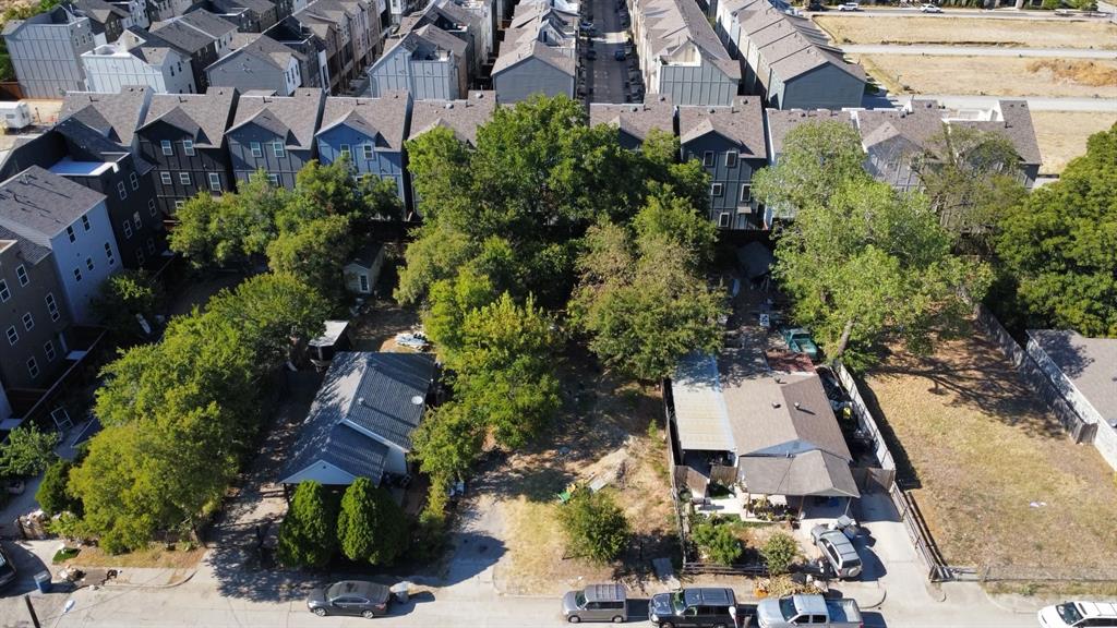 an aerial view of a house with garden space and street view