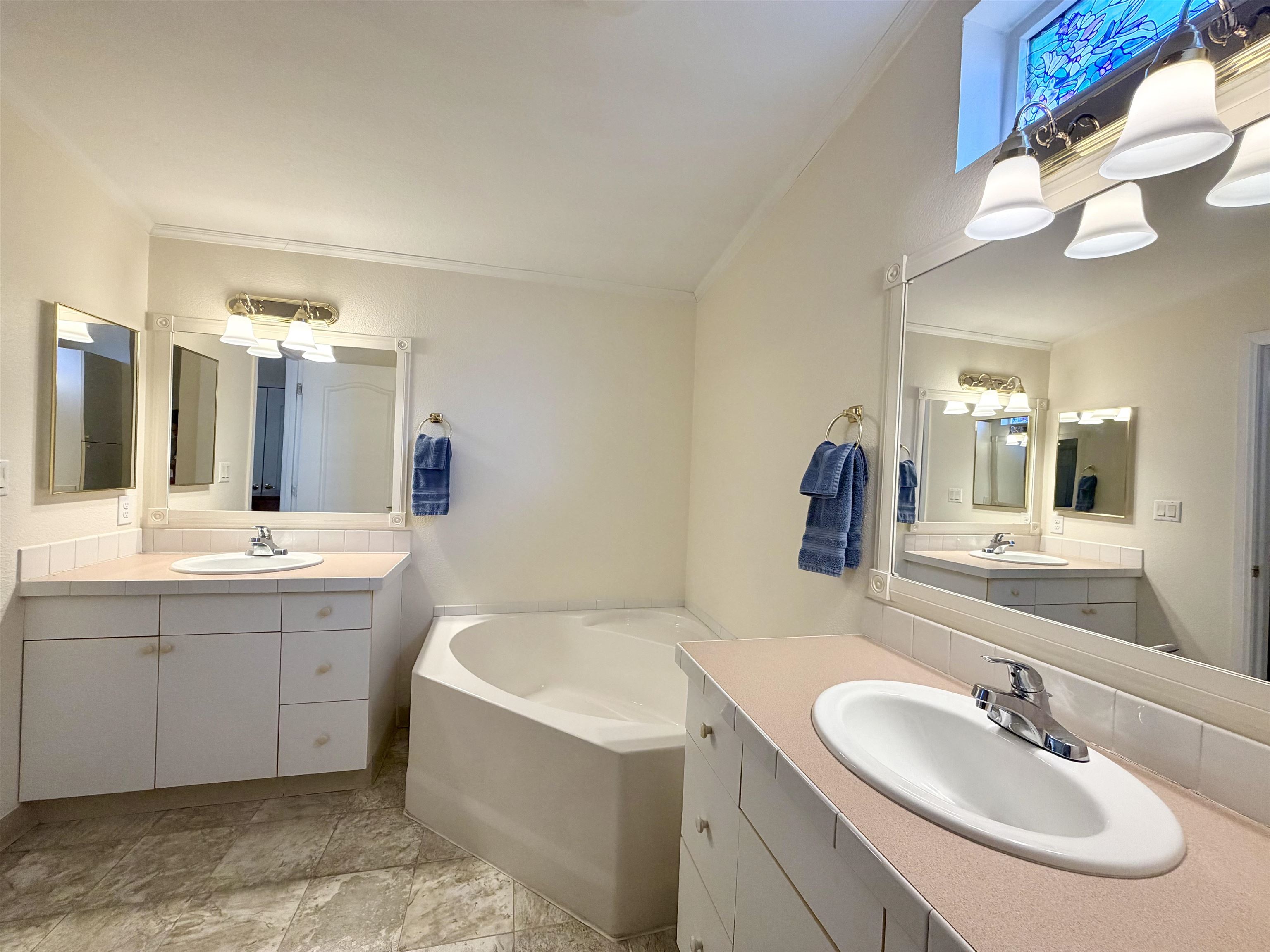 435 32 Road, Unit 480 Clifton, CO 81520 - Photo 14 of 23 a bathroom with a double vanity sink mirror and bathtub