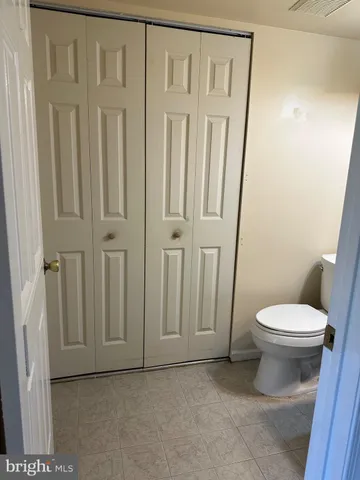 a white toilet sitting next to a sink