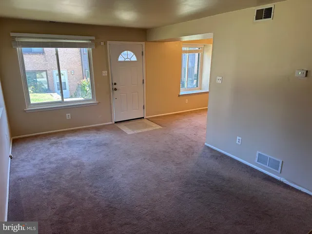 an empty room with windows and closet